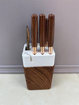 Home & Beyond Co kitchenware knife set with stainless steel blades and black handles displayed on a wooden countertop.