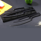 Home & Beyond Co kitchen knife set with fruit knives, including multiple knives displayed on a wooden cutting board.