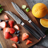 Home & Beyond Co Damascus steel chef's knife set with multiple knives displayed on a wooden cutting board.