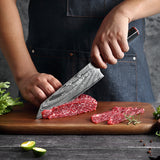 Damascus steel chef's knife set by Home & Beyond Co, featuring multiple knives with intricate blade patterns on a wooden block.