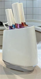 Home & Beyond Co kitchenware knife set with stainless steel blades and black handles, displayed on a wooden kitchen countertop.