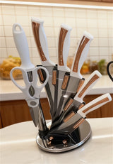 Home & Beyond Co kitchenware knife set with stainless steel knives and black handles on a wooden countertop.
