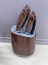 Home & Beyond Co kitchenware knife set with stainless steel blades and black handles, arranged on a wooden countertop.