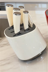 Home & Beyond Co kitchenware knife set with stainless steel blades and black handles, displayed on a wooden countertop.