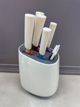 Home & Beyond Co kitchenware knife set with stainless steel blades and black handles, arranged on a wooden countertop.