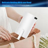 Home & Beyond Co portable projector displaying a bright image on a wall with a sleek black design.