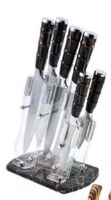 Set of Home & Beyond Co kitchenware knives with black handles and stainless steel blades on a wooden countertop.