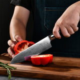 Damascus chef kitchen knife set by Home & Beyond Co, featuring multiple high-quality, patterned Damascus steel knives on a wooden block.