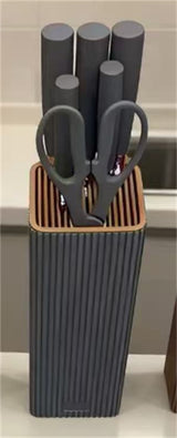 Home & Beyond Co kitchenware knife set with sleek stainless steel blades and black handles arranged on a wooden countertop.